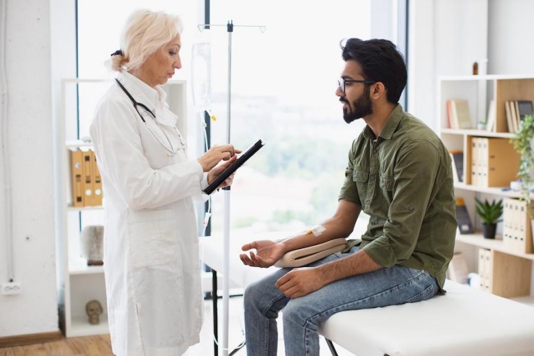 young man on a doctor consultation receiving chemotherapy drugs