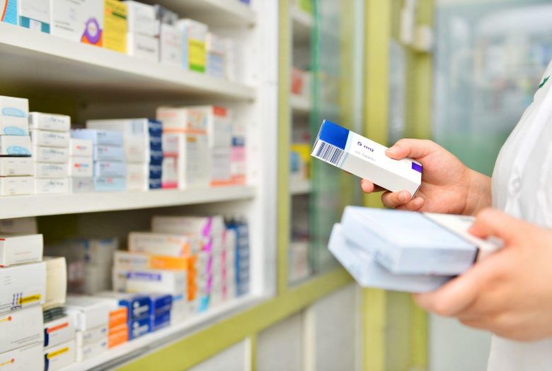 pharmacist stocking the shelves at a drugstore