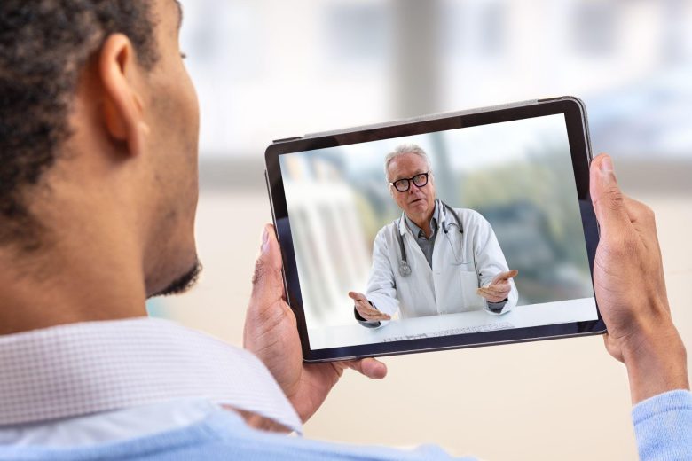young male patient on a video call with his doctor