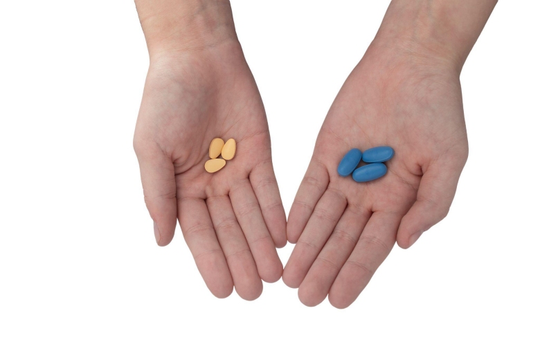 Hands holding pills can you take Viagra with blood pressure medication