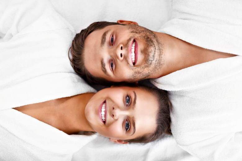 couple in white ropes laying next to each other