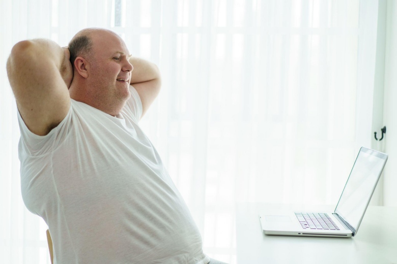 Overweight male smiling.