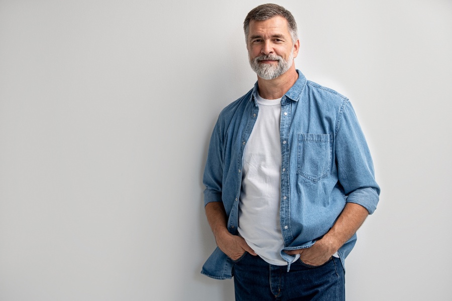 Confident middle-aged man smiling, men's sexual health and ED topic
