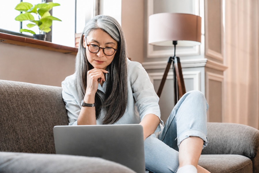 Woman at home using laptop.